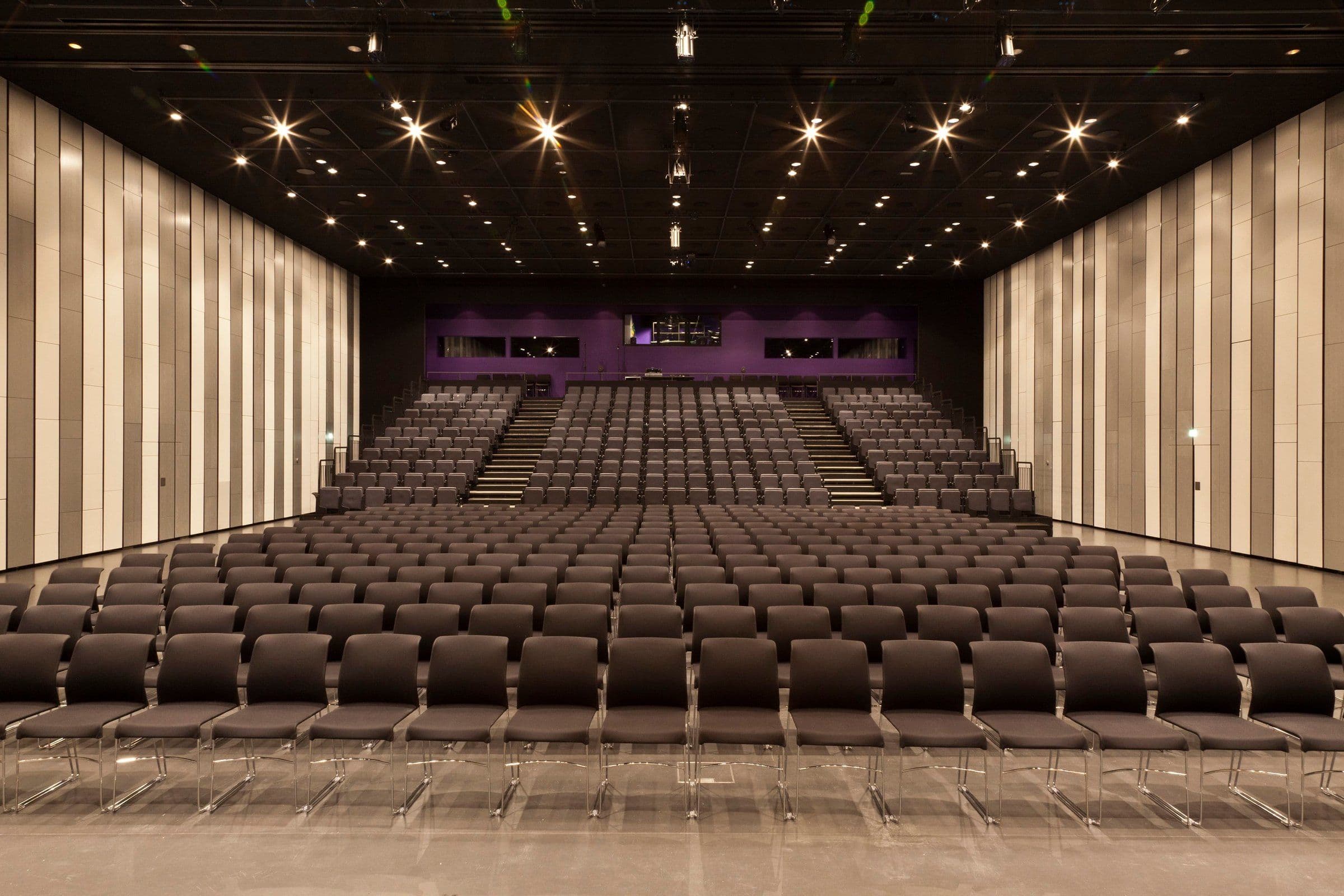 a large room with tables and chairs set up for a party