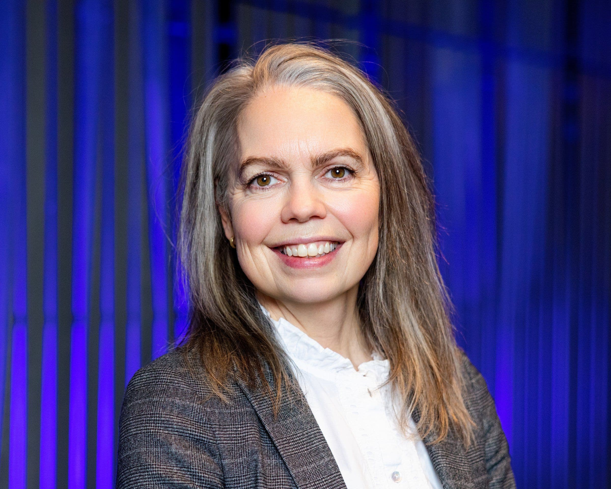 a large crowd of people are watching a concert in a large auditorium .